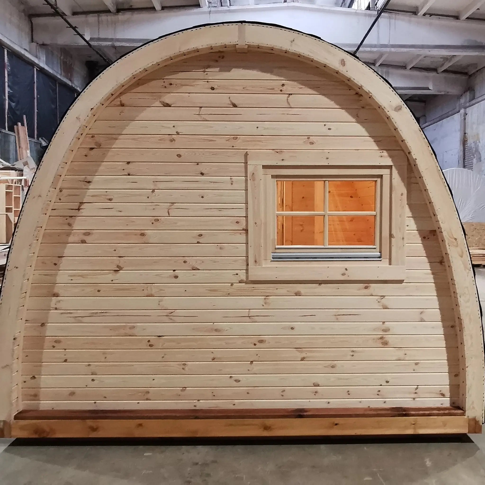Rear exterior view of the Hearthwood luxury 6 person glamping pod with timber cladding and curved roof