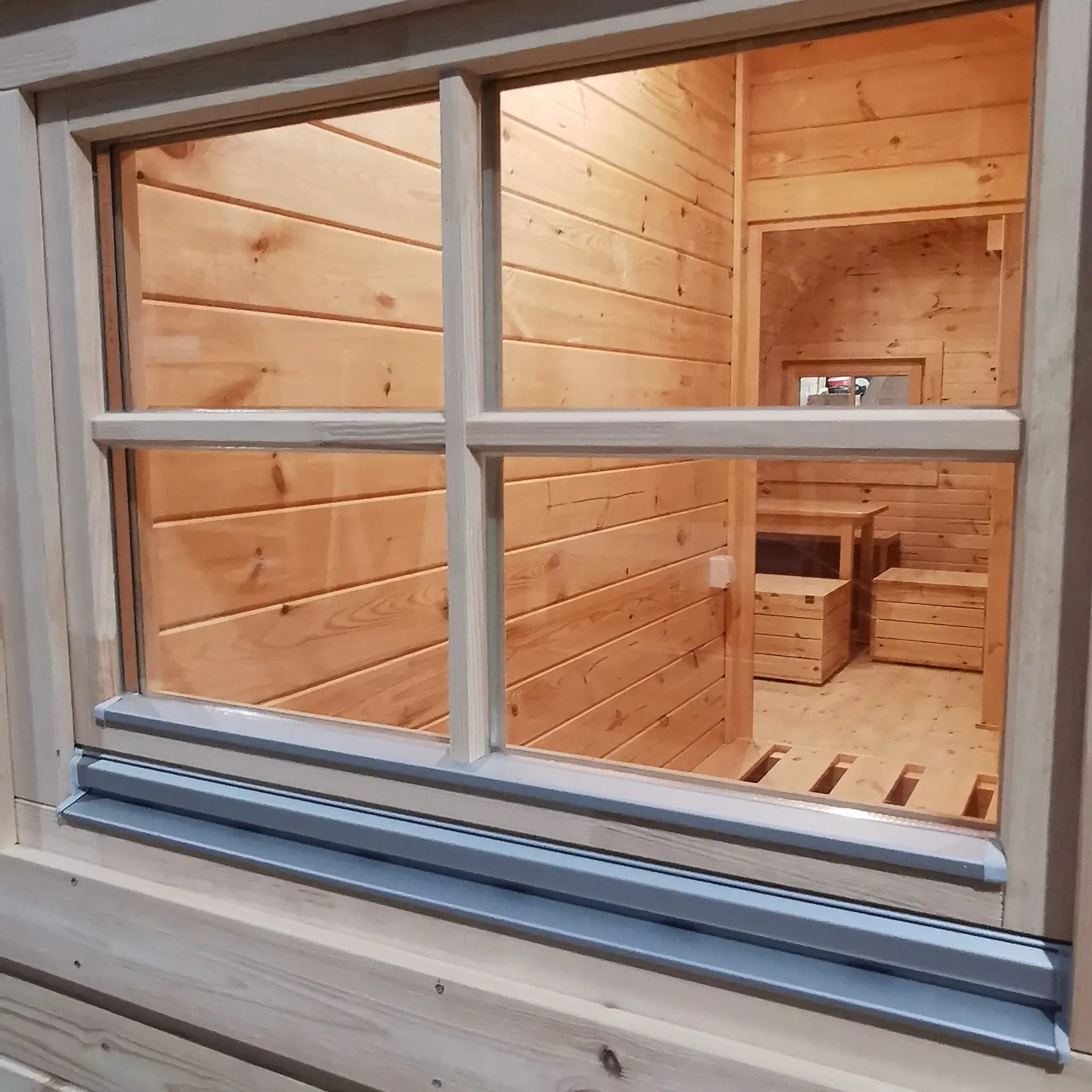 Rear window detail on the Hearthwood luxury 6 person glamping pod showing timber construction