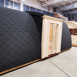 Alternate side exterior view of the Hearthwood luxury 6 person glamping pod with timber walls and shingle roof