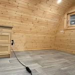 Spacious empty living area with curved timber interior in The Hearthwood Pod luxury family glamping pod