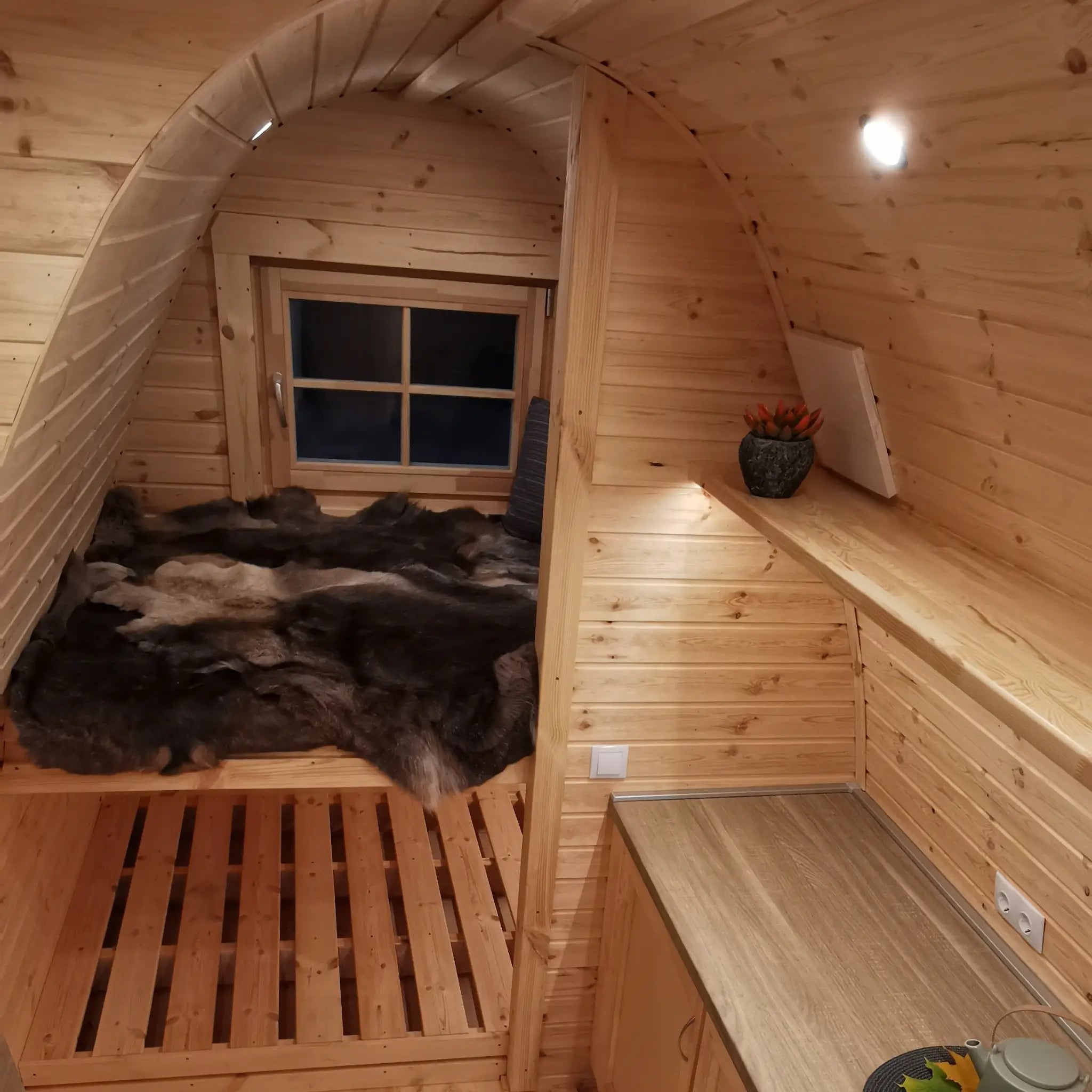 Bunk bed layout inside the Hearthwood Pod luxury glamping pod, featuring handcrafted wooden bunks, soft furnishings, and space-efficient design.