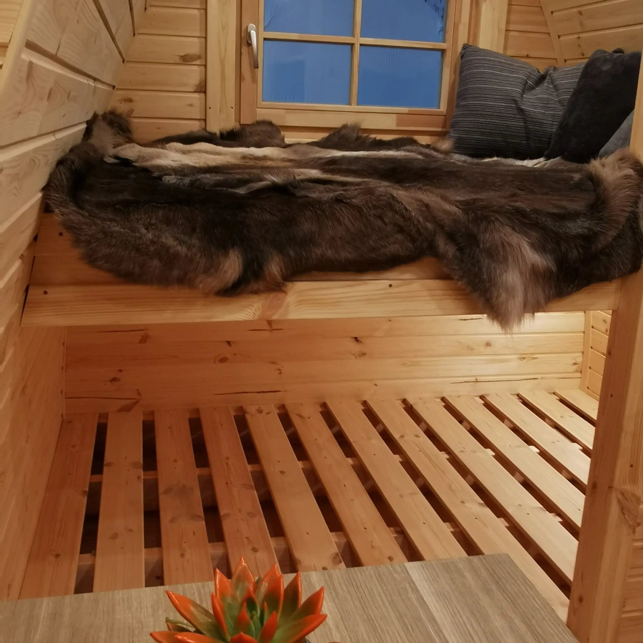 Detailed view of timber bunk bed craftsmanship inside The Hearthwood glamping pod