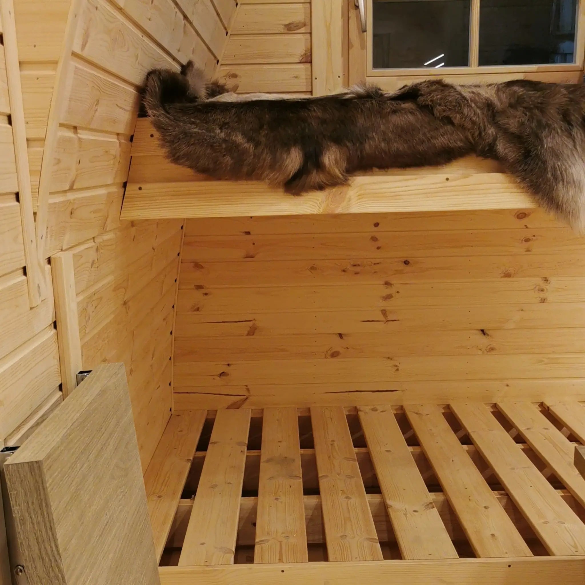 Close-up of upper bunk bed with natural timber finish inside The Hearthwood Pod