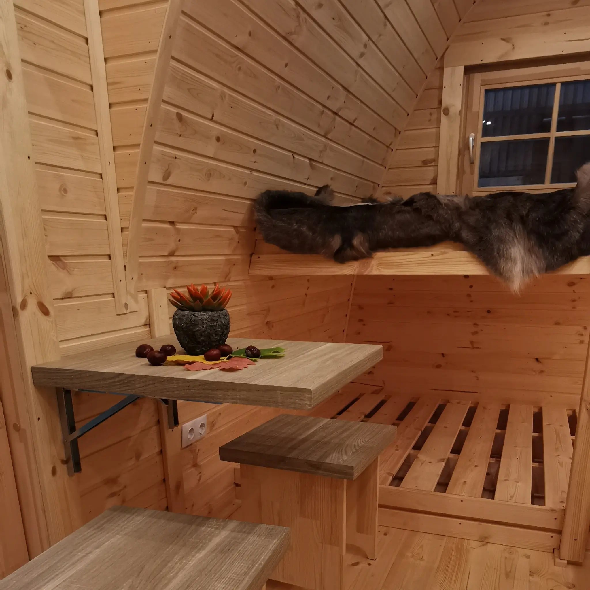 Cosy bunk bed and dining area inside The Hearthwood luxury 2 person glamping pod