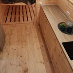 Kitchen counter and timber flooring inside The Hearthwood luxury glamping pod