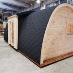 Exterior side view of The Hearthwood Pod luxury 6 person glamping pod with curved timber structure and insulated black shingle roof