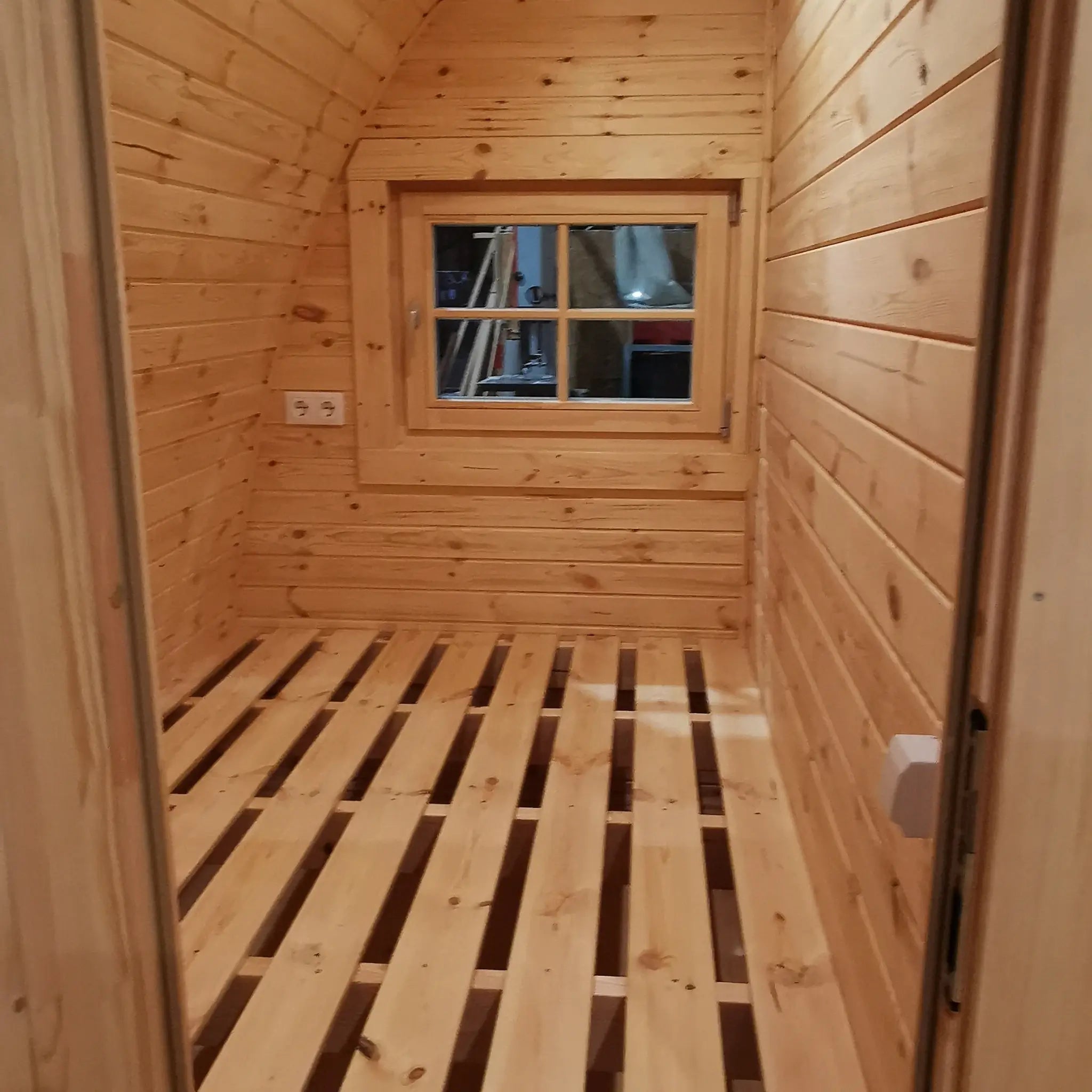 Interior bedroom featuring a double bed in The Hearthwood Pod luxury 6 person glamping pod