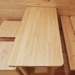 Close-up of solid timber dining table inside The Hearthwood Pod luxury 6 person glamping accommodation