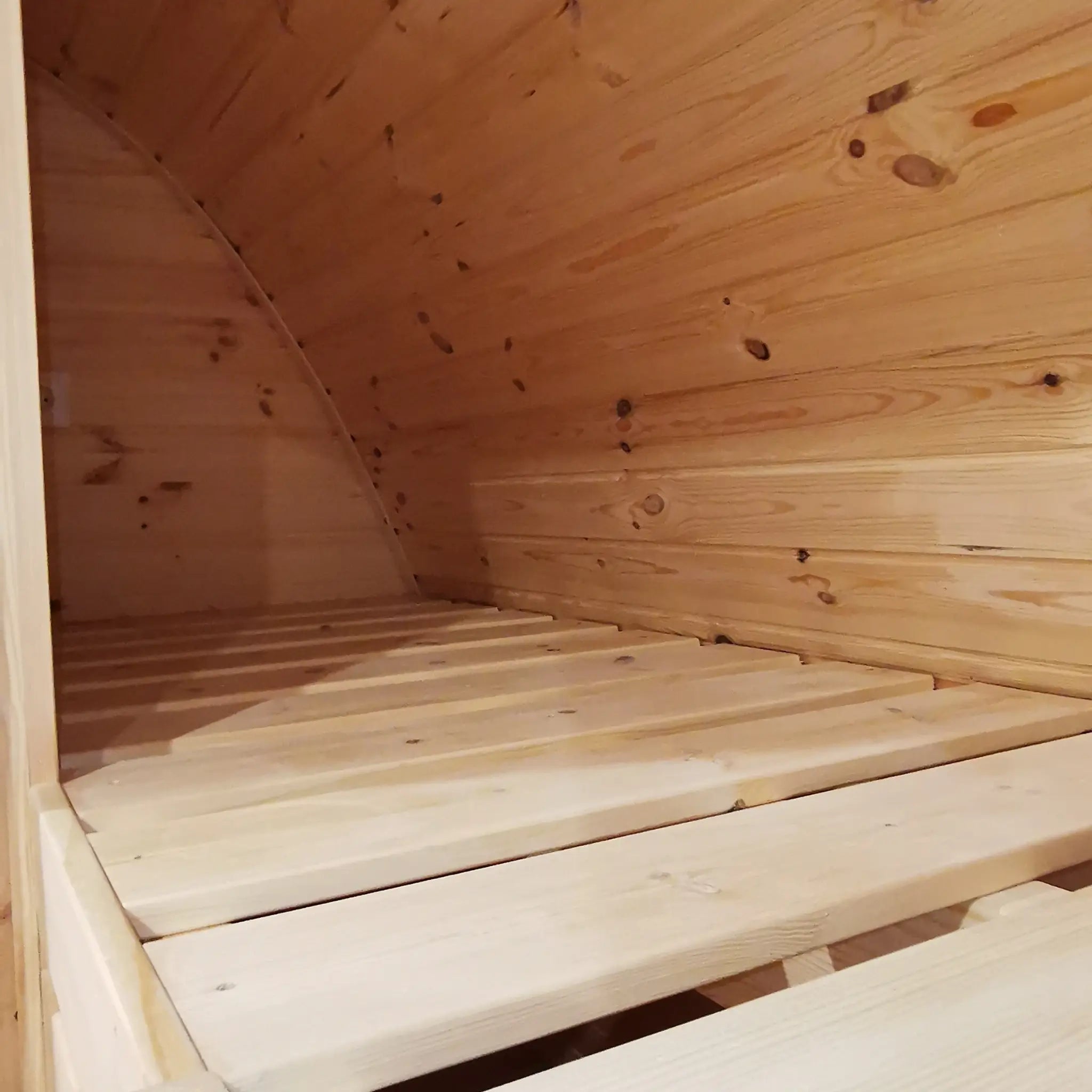 Top bunk detail showing solid timber construction in the Hearthwood luxury 6 berth glamping pod