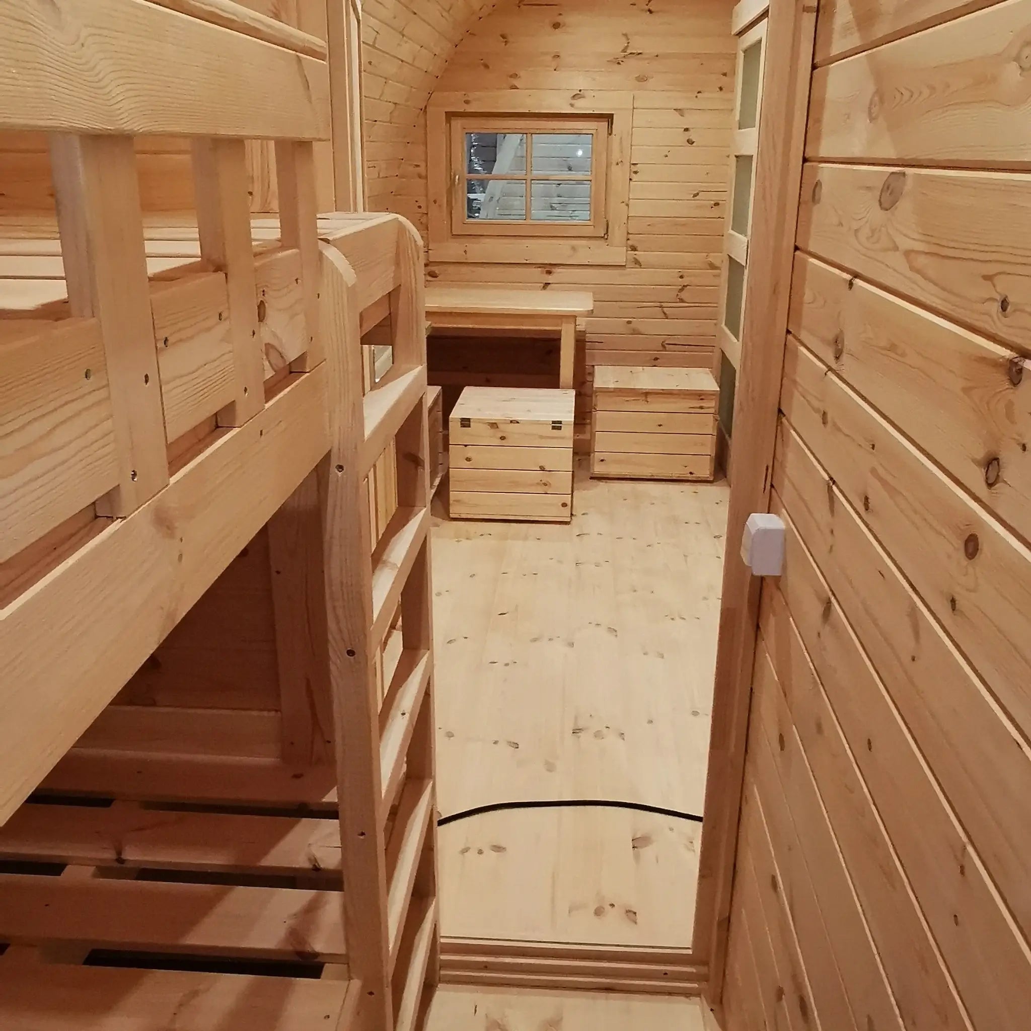 View from bunk bed bedroom looking towards dining area in the Hearthwood Pod luxury family glamping pod