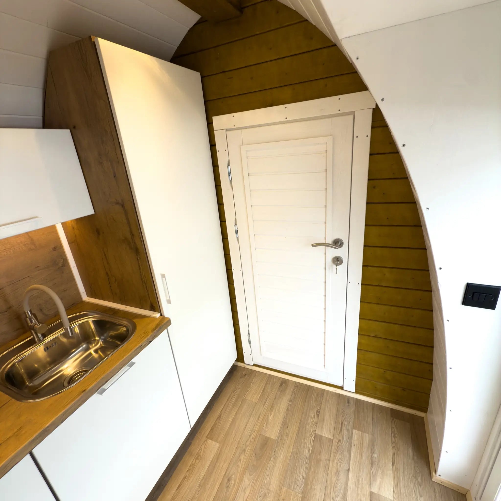 Interior View of Hobbit Pod Entrance Area with Kitchen Counter