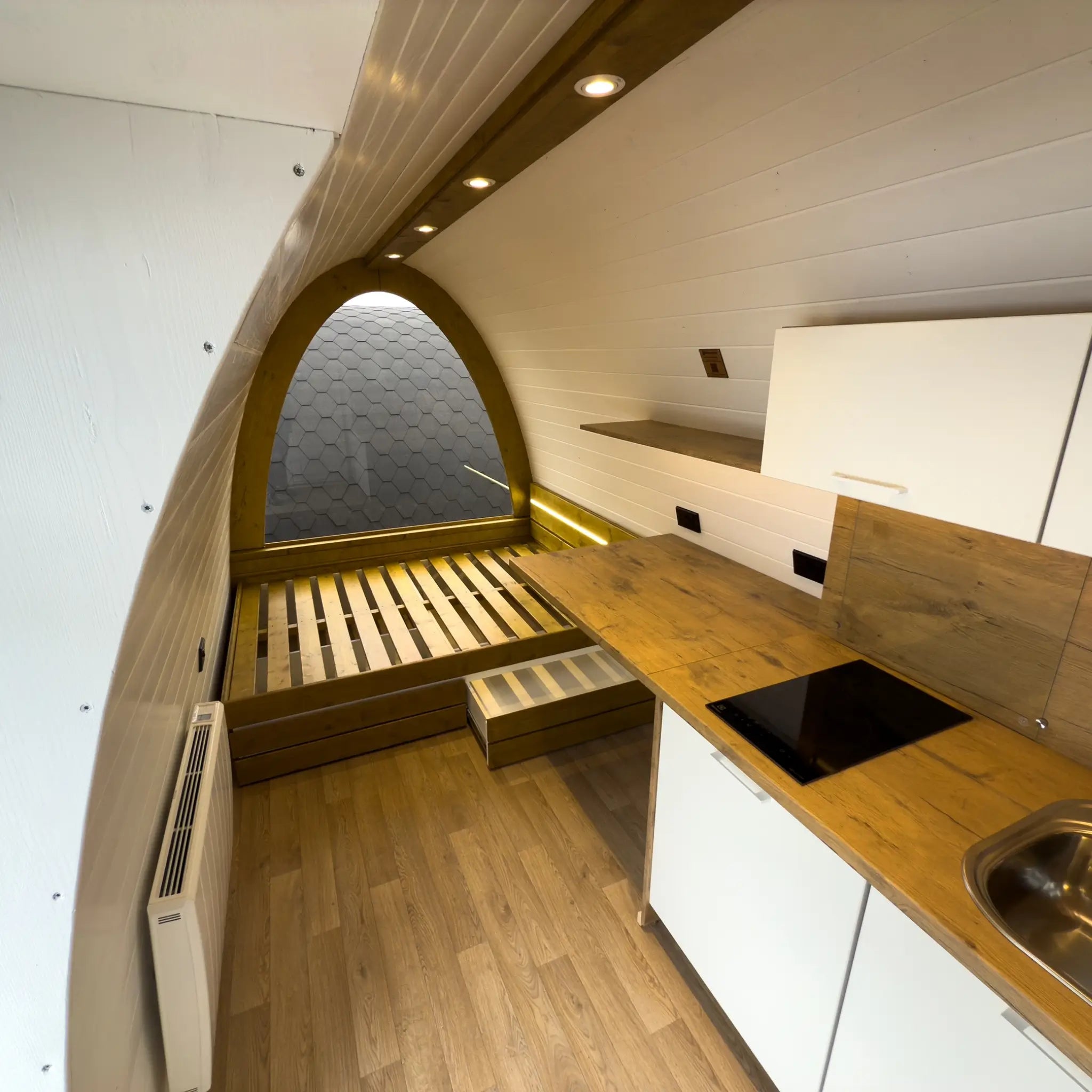 Interior View of Hobbit Pod Bedroom Platform and Kitchen Layout