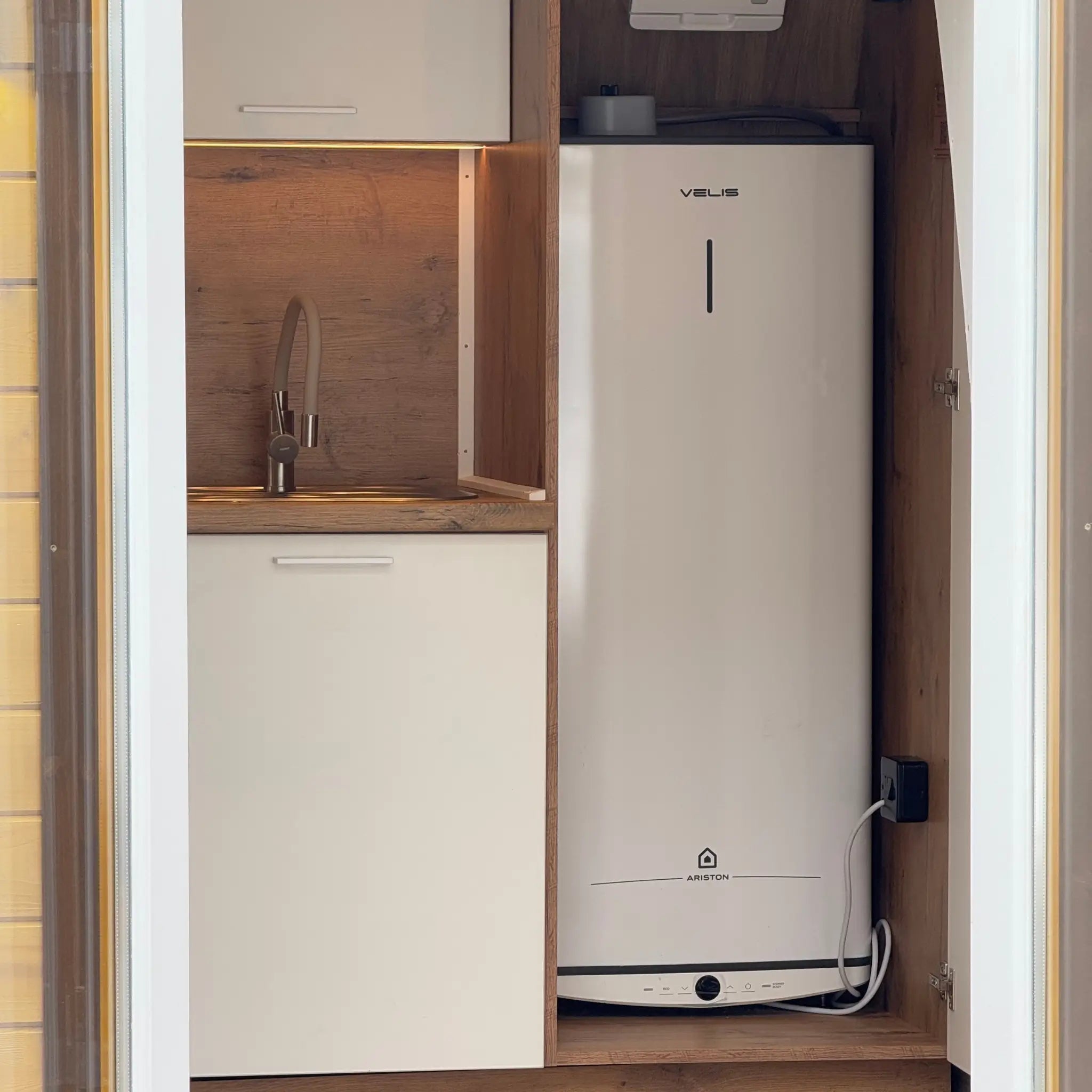 Hot Water Heater Installed in Kitchen Cabinet of Hobbit Pod