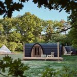 Front view of The Hobbit Pod luxury glamping pod on a timber deck in a woodland setting