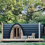 Front close-up of The Hobbit Pod luxury glamping pod with timber entrance and outdoor decking