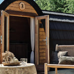Luxury Hobbit Pod glamping pod with French doors open onto a spacious timber deck