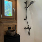 Modern ensuite shower room with stone basin inside The Hobbit Pod luxury glamping pod