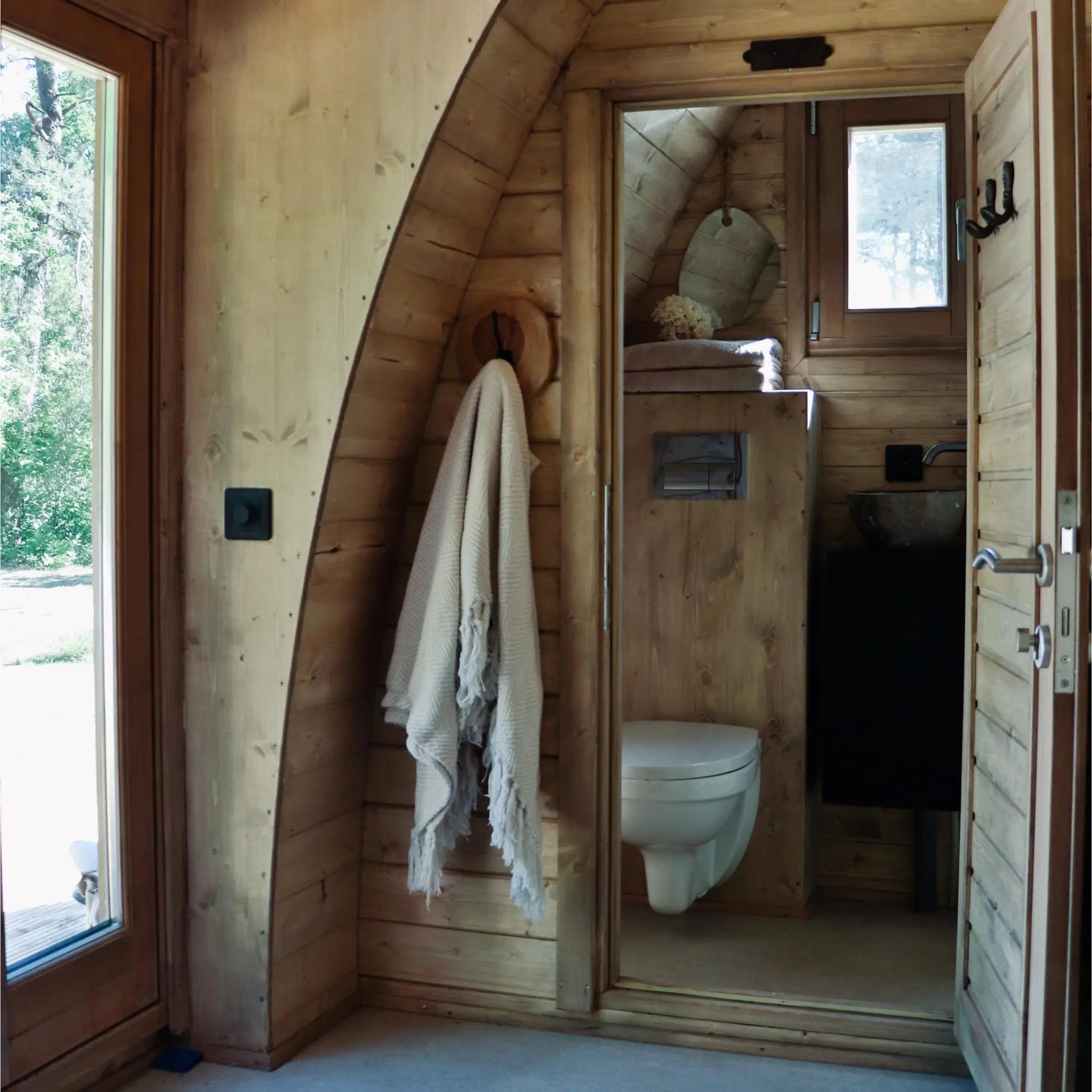 View towards the ensuite bathroom from inside The Hobbit Pod luxury glamping pod