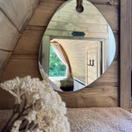 Decorative mirror and natural timber interior inside The Hobbit Pod luxury glamping pod