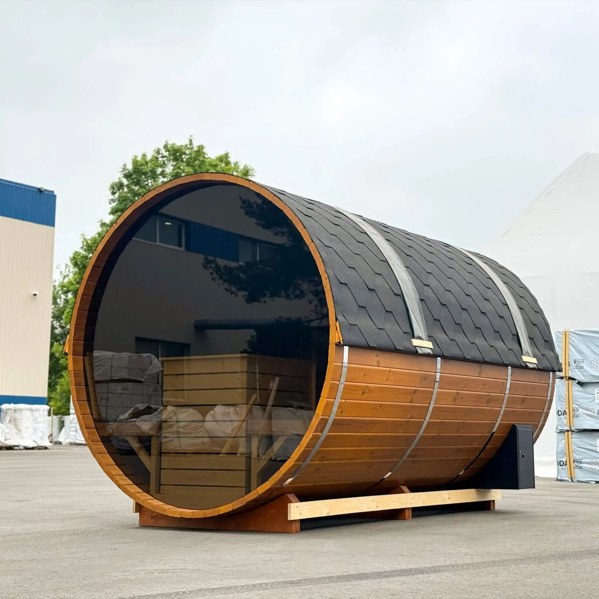 Side perspective of the Infinity Glass luxury barrel sauna highlighting the panoramic glass wall