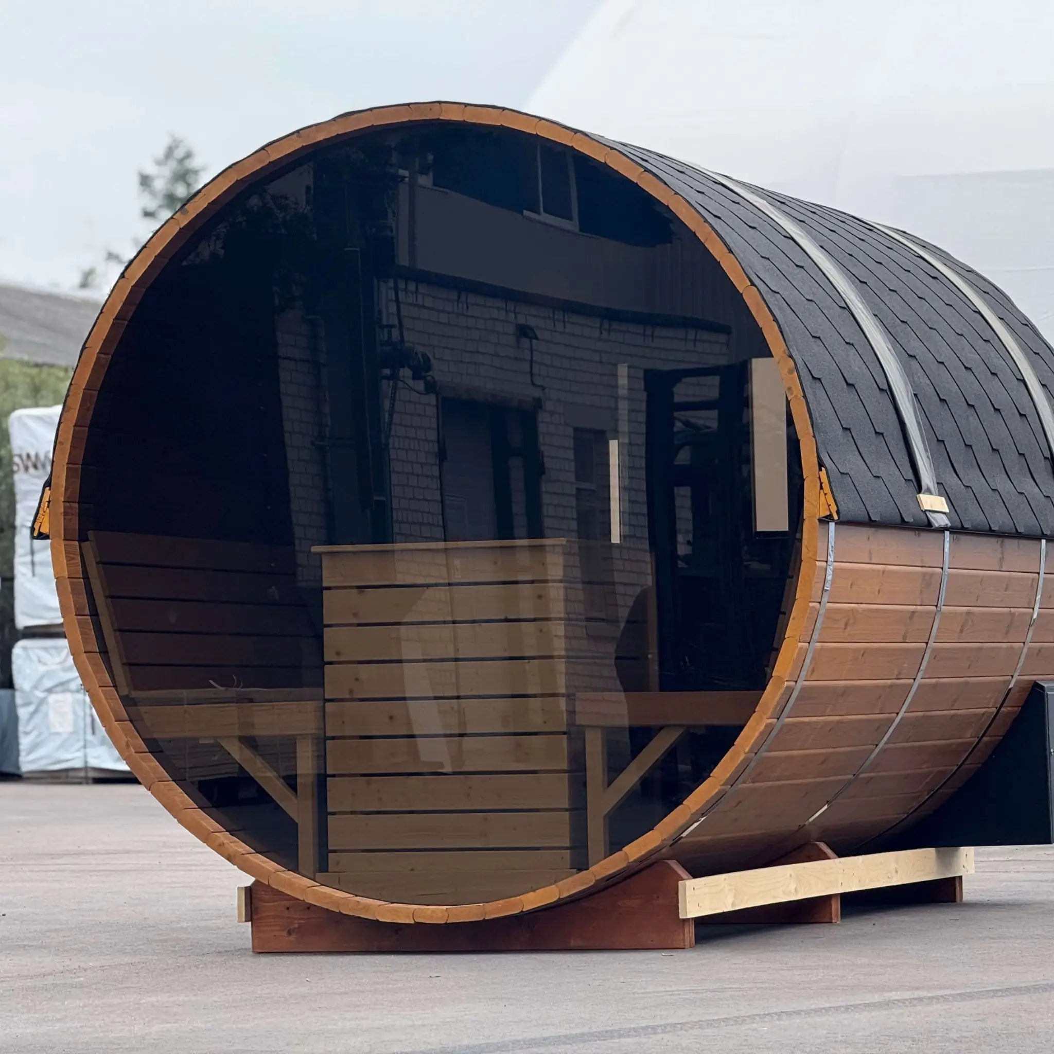 Front angled view of the Infinity Glass luxury barrel sauna with panoramic rear glazing