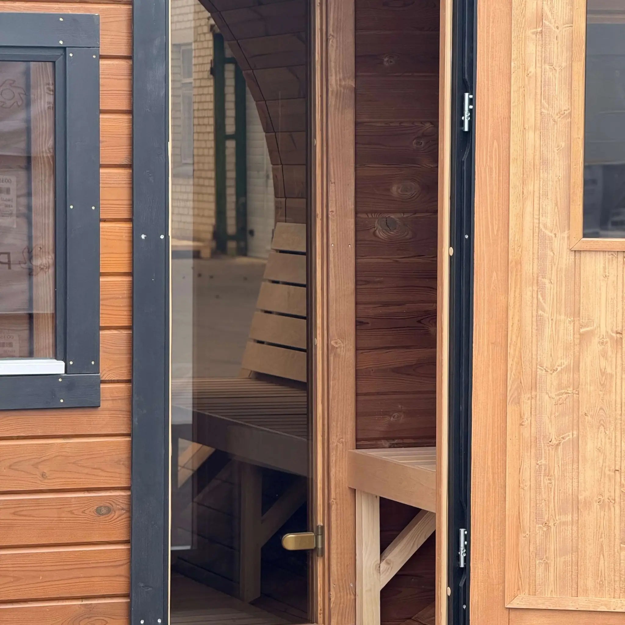 View from the entrance into the changing room and sauna room inside the Infinity Glass barrel sauna