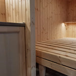 The Medium GlampTainer container-style glamping structure – wooden bed frame next to kitchenette with warm pine cladding