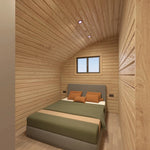 Interior bedroom of the Moonburrow Pod luxury glamping accommodation, featuring a comfortable double bed, warm timber walls, and soft ambient lighting.
