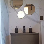 Modern bathroom sink and round mirrors inside luxury shepherd’s hut bathroom