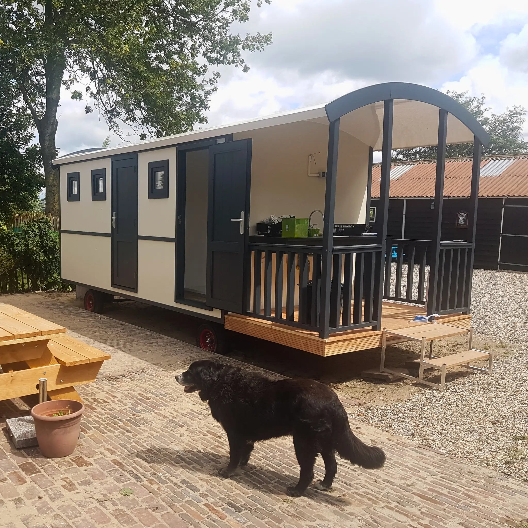 Modern washroom hut exterior with covered entrance decking and countryside setting