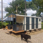 Angled exterior view of luxury washroom hut with covered decking and outdoor sink area