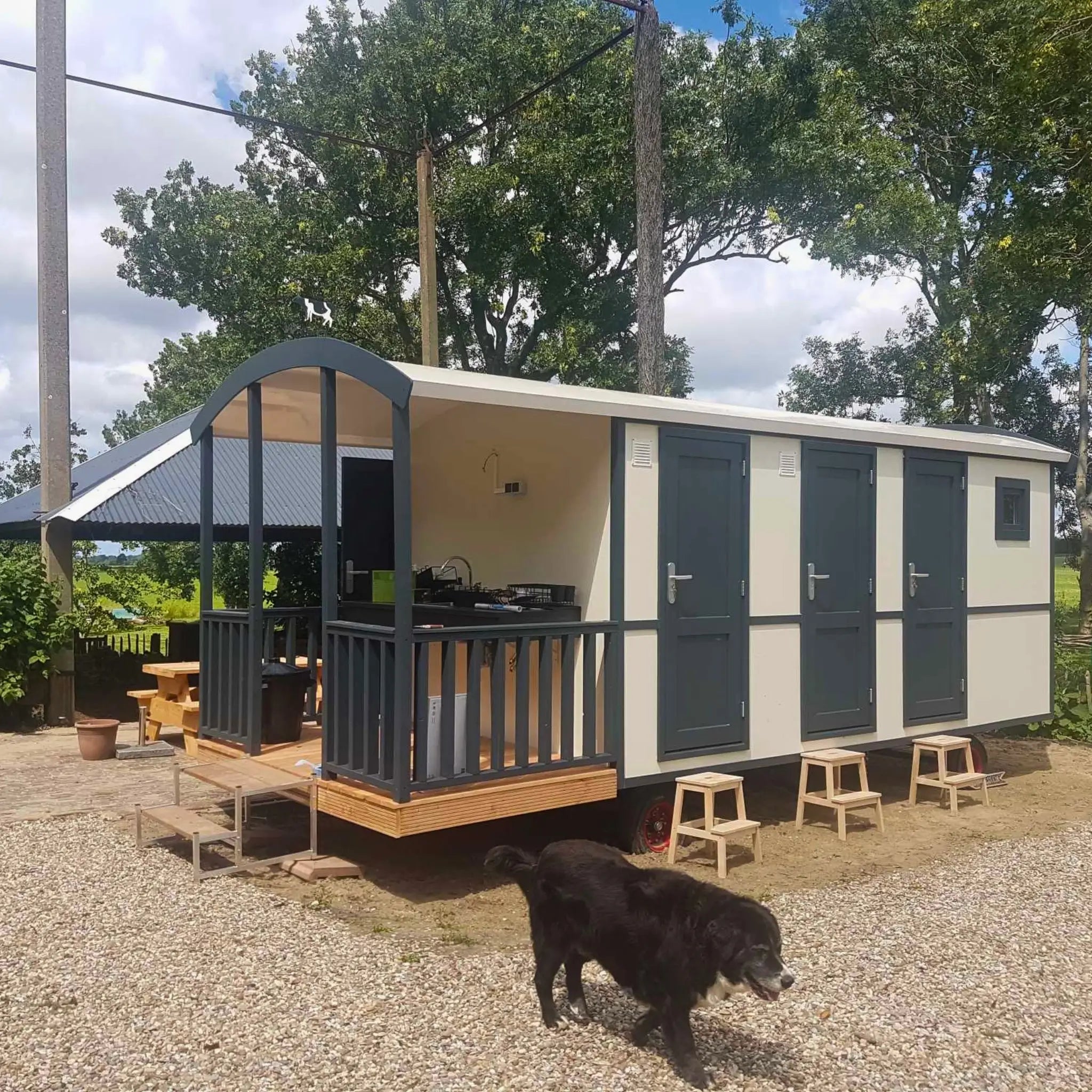 Angled exterior view of luxury washroom hut with covered decking and outdoor sink area