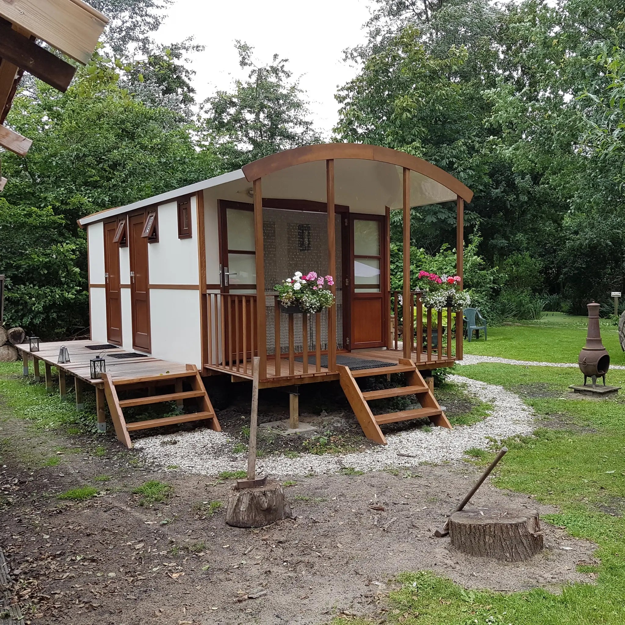 Rear exterior view of washroom hut with timber cladding and countryside surroundings