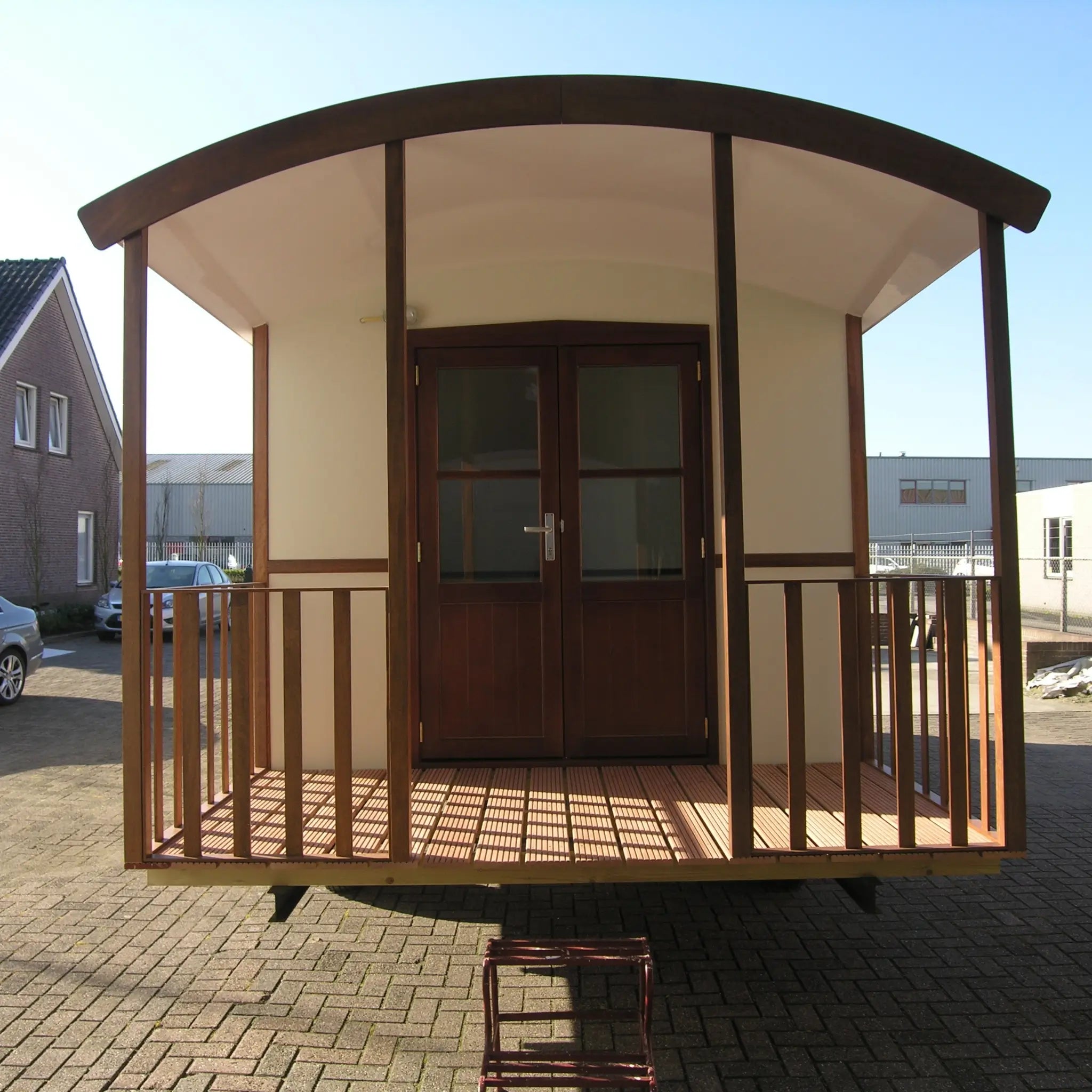 Front entrance view of washroom hut with covered porch and double doors