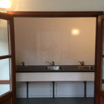 Triple stainless steel sink vanity area inside contemporary washroom shepherds hut