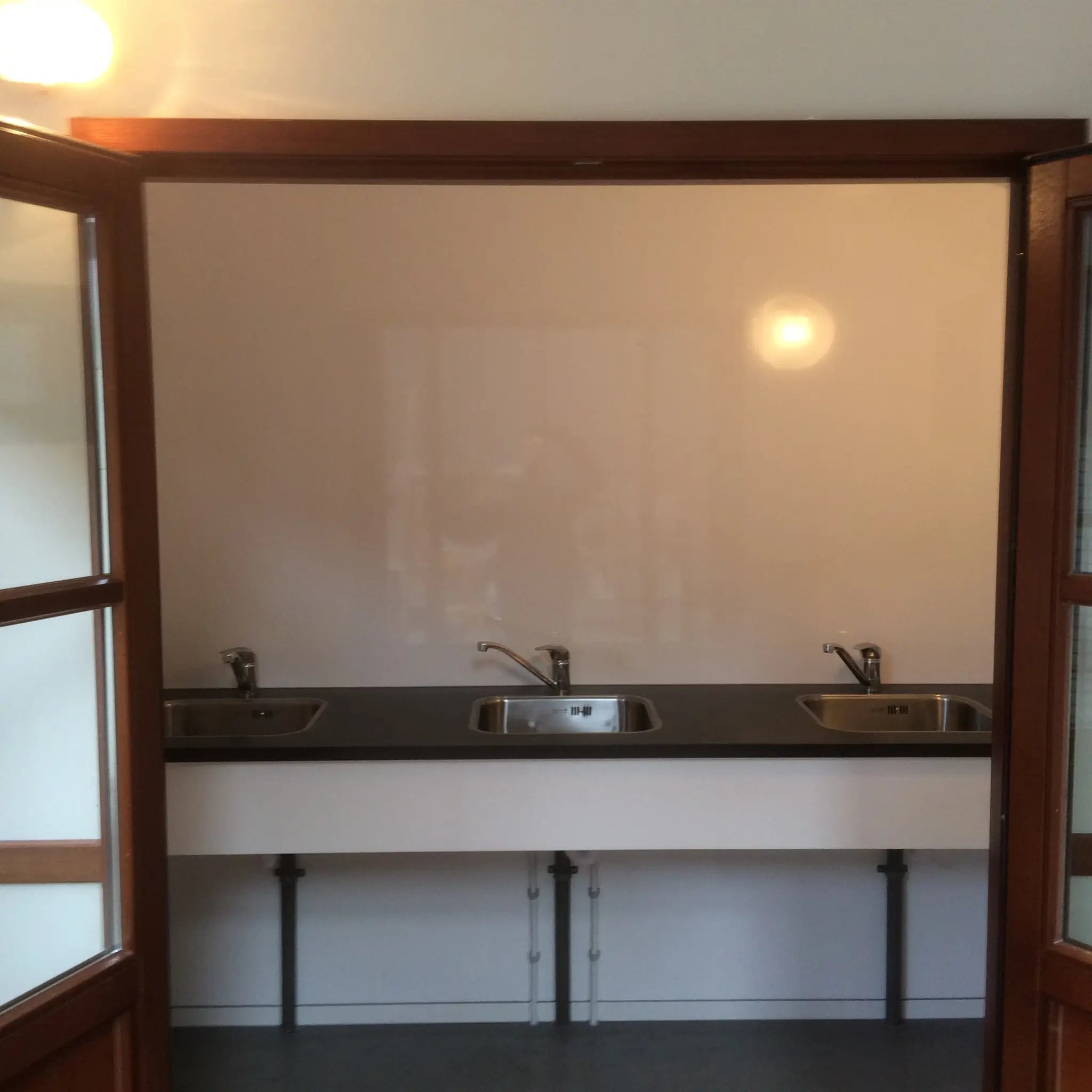 Triple stainless steel sink vanity area inside contemporary washroom shepherds hut