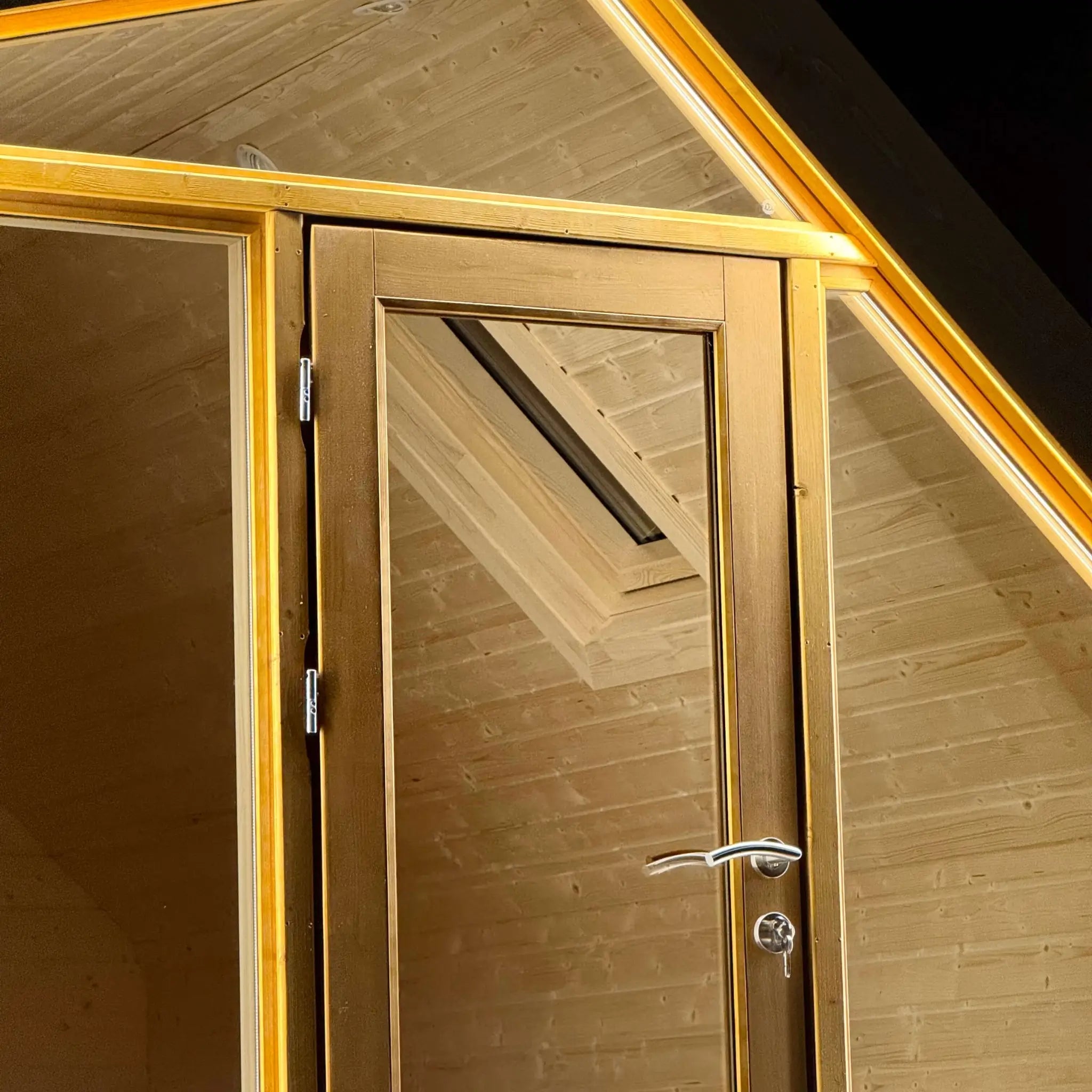 Close-up of the entrance door on The Ridgefall Pod 2 person glamping pod, featuring glazed timber doors and high-quality hardware.
