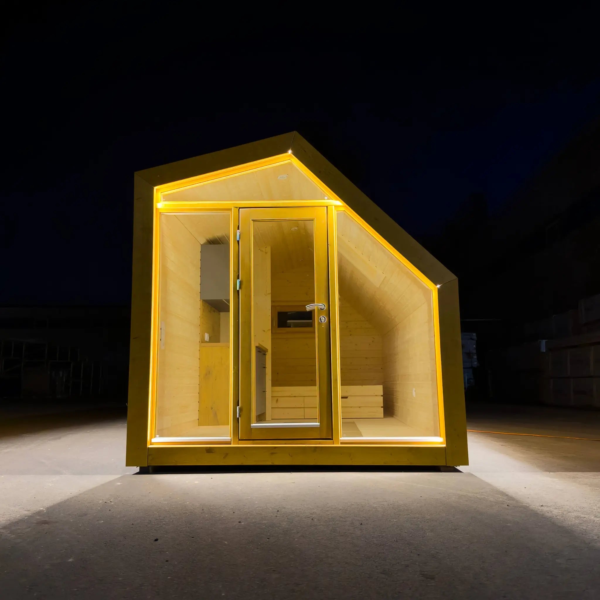 Front exterior view of The Ridgefall Pod, a 2 person glamping pod with a distinctive pitched roof and full-height glazed entrance.