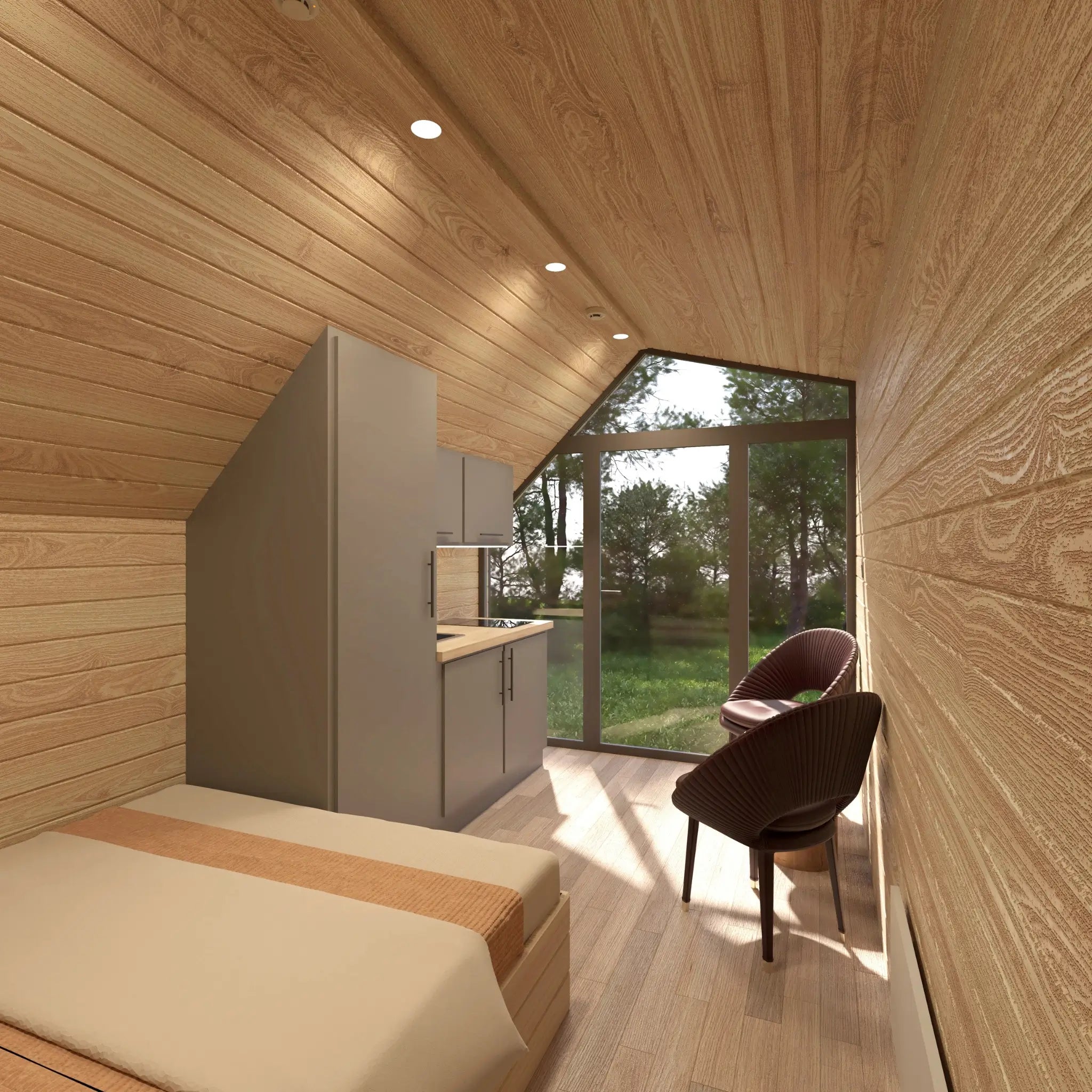 Open-plan interior view from sleeping area inside luxury glamping pod with kitchenette, panoramic glazing and natural wood finish.