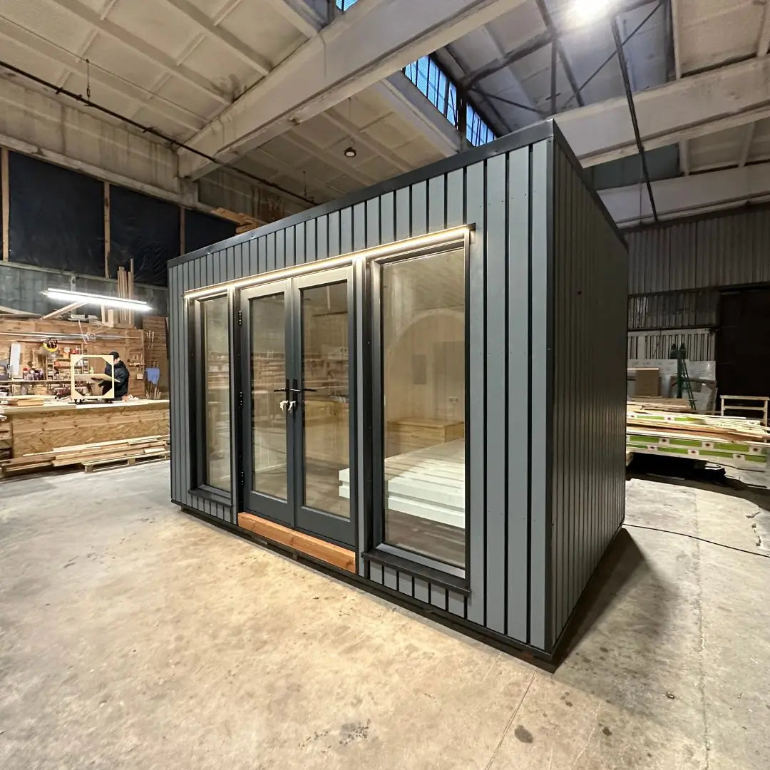 The Small GlampTainer container-style glamping structure – right side perspective highlighting full-height glass doors and contemporary exterior cladding.