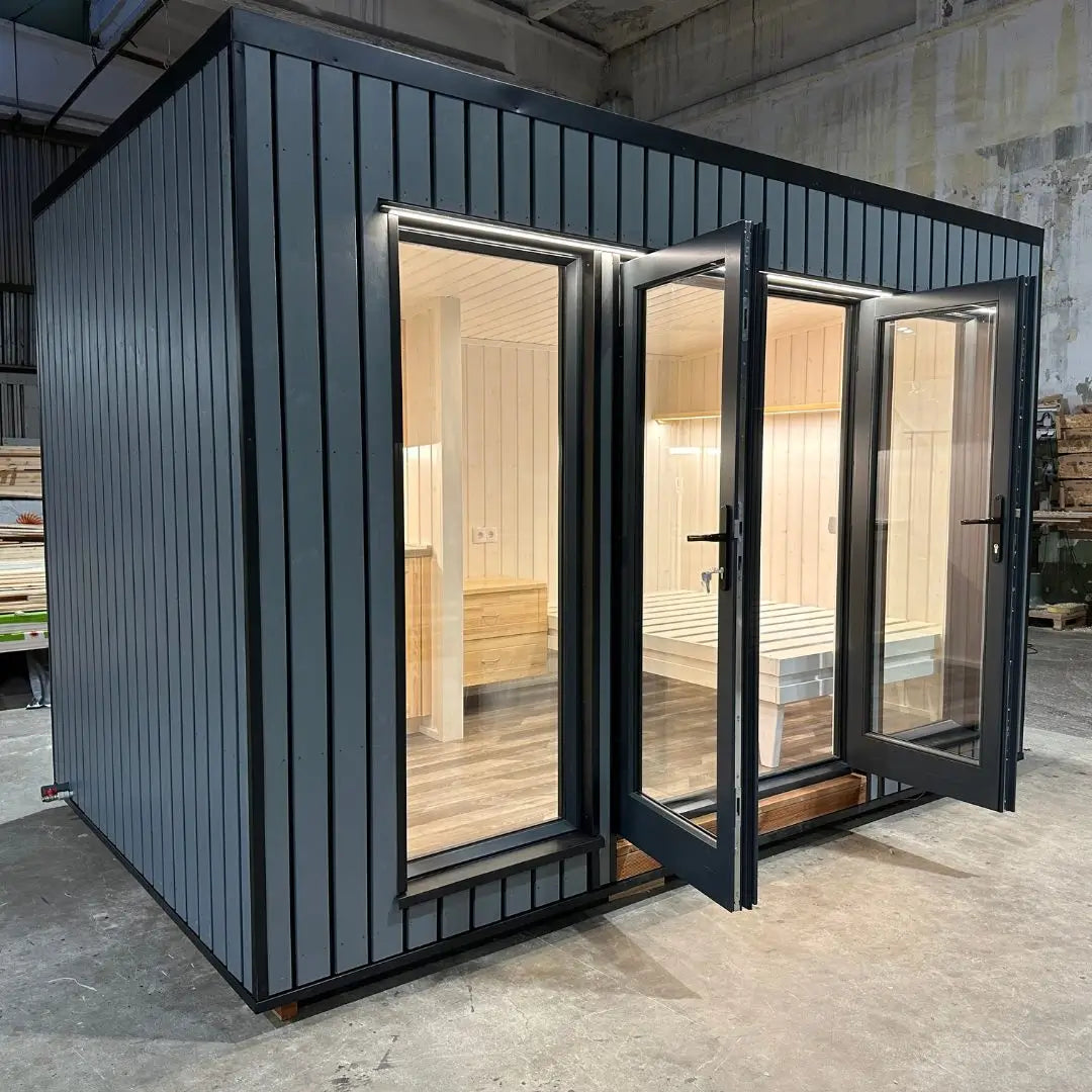 The Small GlampTainer container-style glamping structure – front view with open French doors inviting into a bright, minimalist wooden interior.