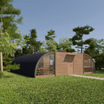 Angled exterior view of the ultimate 2 person glamping pod with curved black roof, timber cladding and large feature windows in a grassland setting.