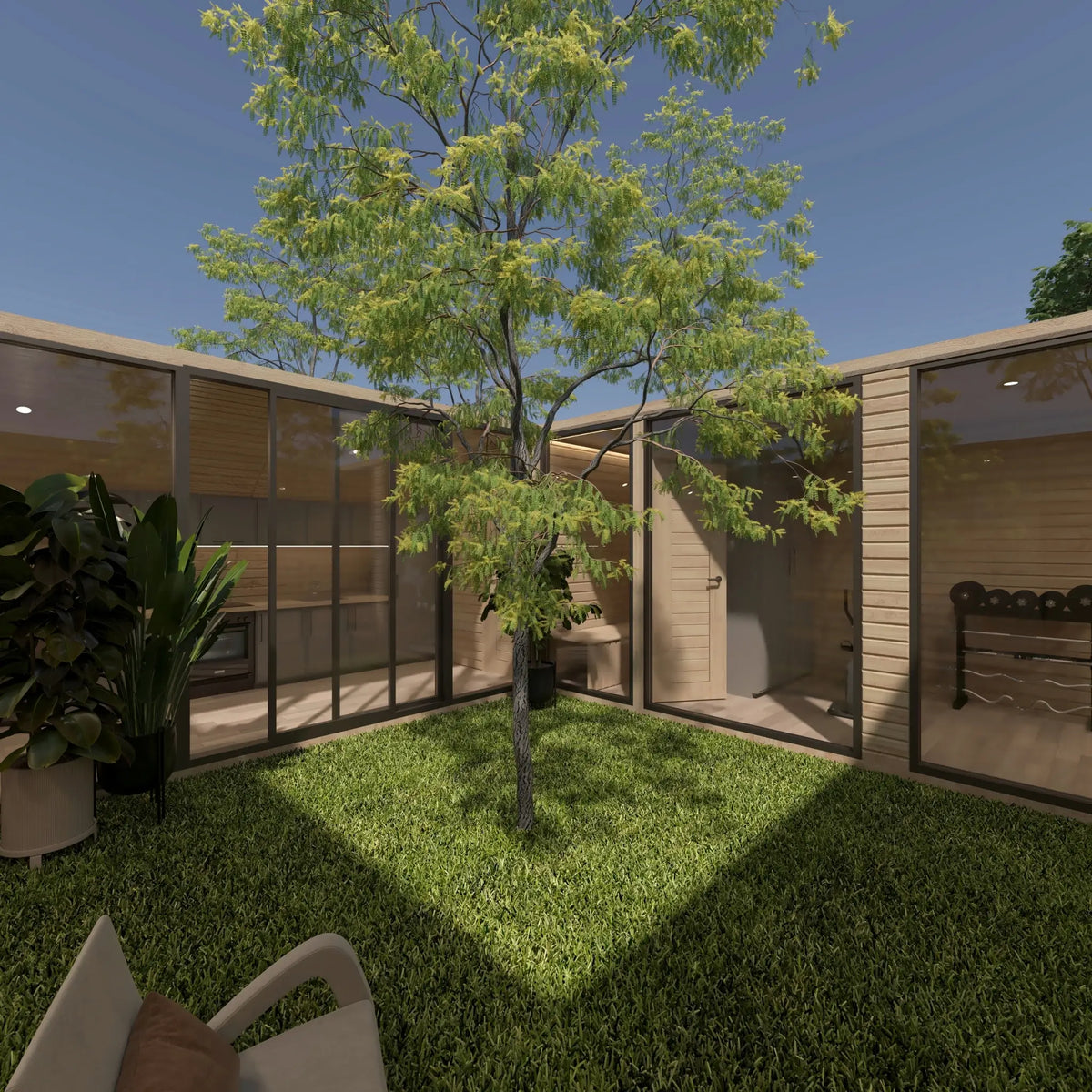 Landscaped central courtyard surrounded by full-height glazing with views into the kitchen, sauna and other interior spaces of the ultimate 2 person glamping pod.