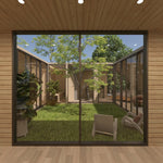 Full-height courtyard glazing offering views towards the private sauna, gym and bedroom areas inside the ultimate 2 person glamping pod.