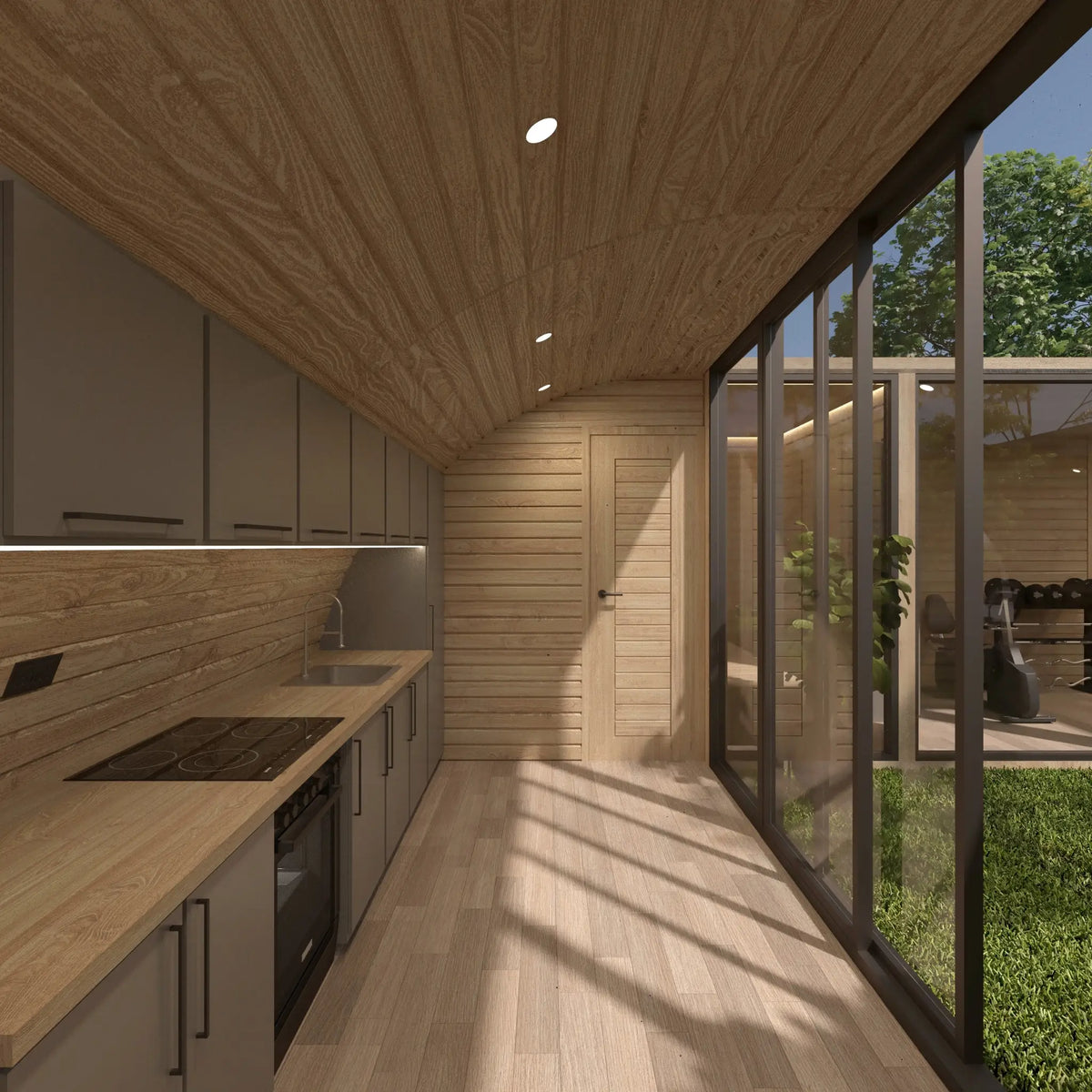 Modern fitted kitchen with timber interior, courtyard glazing and bathroom access inside the ultimate 2 person glamping pod during daylight.