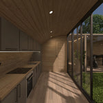 Modern fitted kitchen with timber finishes, integrated appliances, courtyard glazing and bathroom access inside the ultimate 2 person glamping pod.
