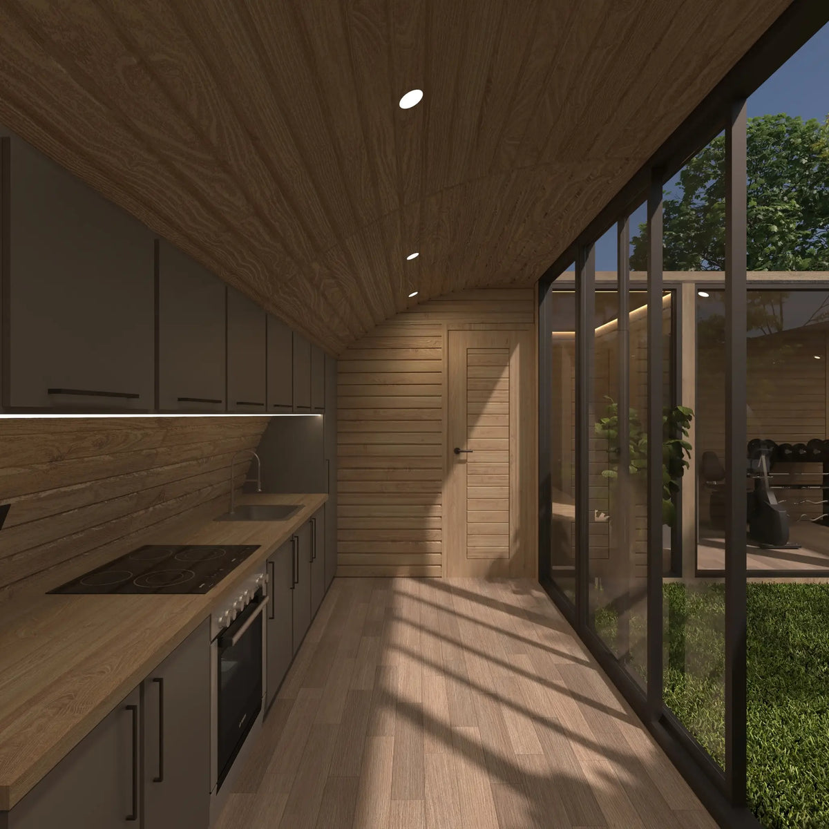 Modern fitted kitchen with timber finishes, integrated appliances, courtyard glazing and bathroom access inside the ultimate 2 person glamping pod.