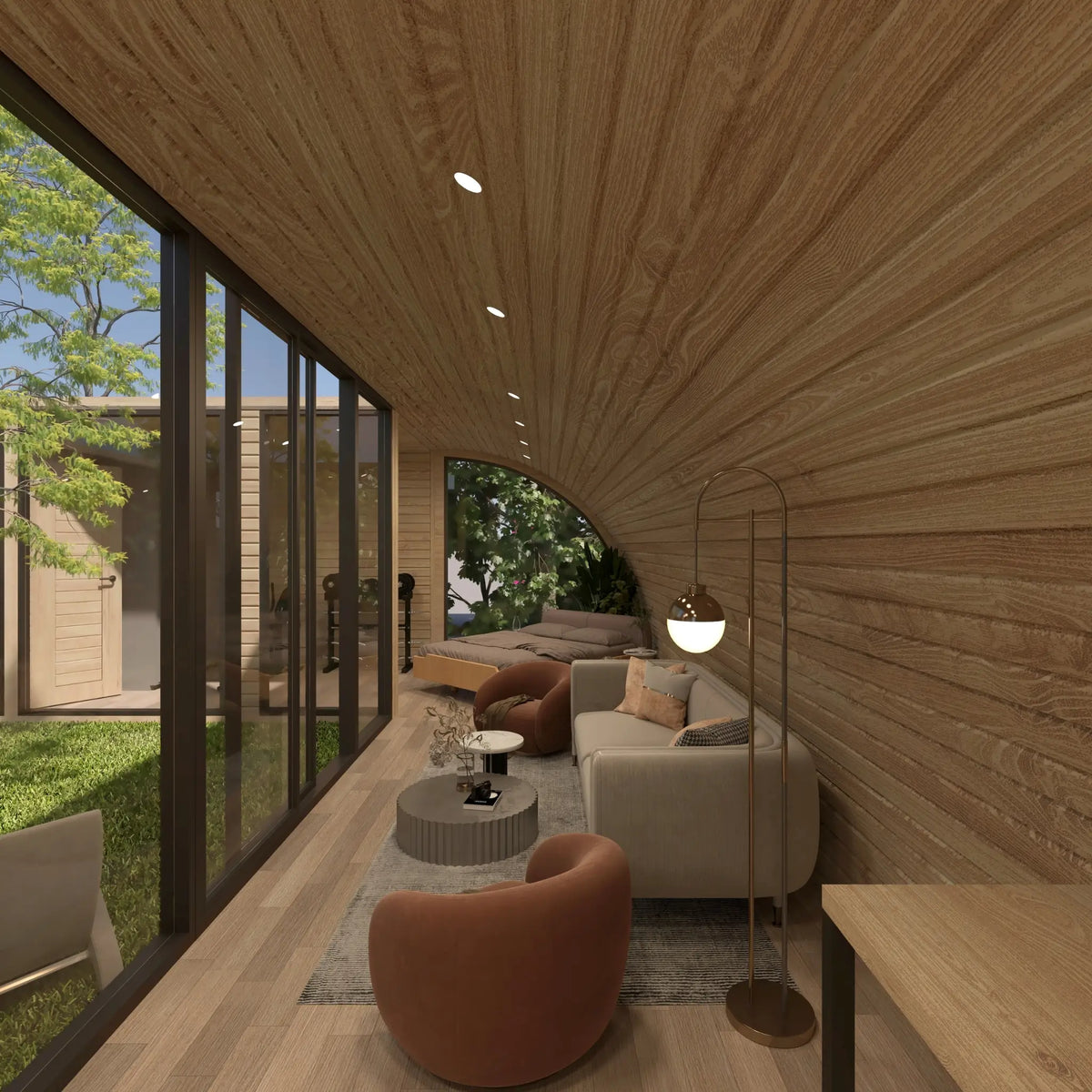 Open-plan living and sleeping area with sofa, lounge chairs, double bed and floor-to-ceiling courtyard glazing inside the ultimate 2 person glamping pod.