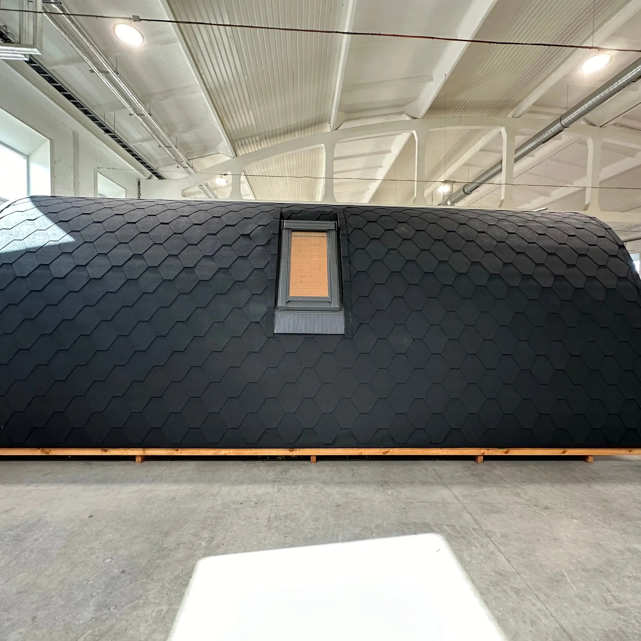 Back view of The Twilight Pod luxury glamping pod with integrated VELUX roof window and curved timber structure