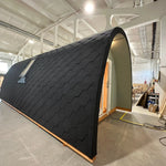 Angled side view of The Twilight Pod showing black shingle cladding and compact luxury glamping design
